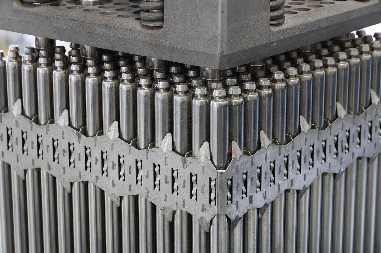 A close-up of nuclear fuel rods arranged in a reactor assembly, illustrating an article on the planned literature survey for a radioactive waste final disposal site at Minami-Tori-shima, Japan.